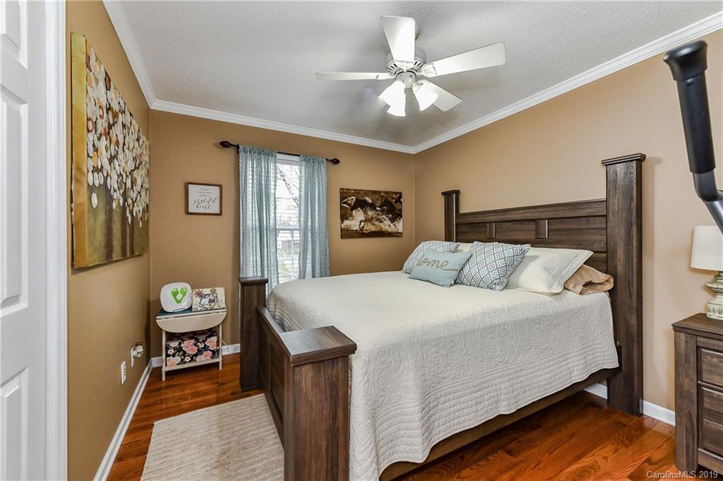 1108 Pinewood Road Rock Hill, SC 29730 - Photo 21 of 26 a bedroom with a bed and a chandelier