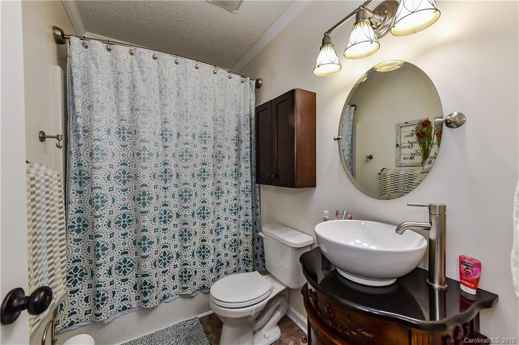 1108 Pinewood Road Rock Hill, SC 29730 - Photo 22 of 26 a bathroom with a toilet a sink and a mirror