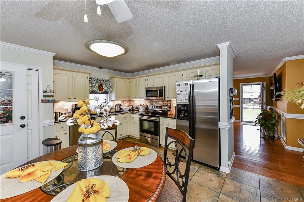 1108 Pinewood Road Rock Hill, SC 29730 - Photo 8 of 26 a kitchen with refrigerator and chairs