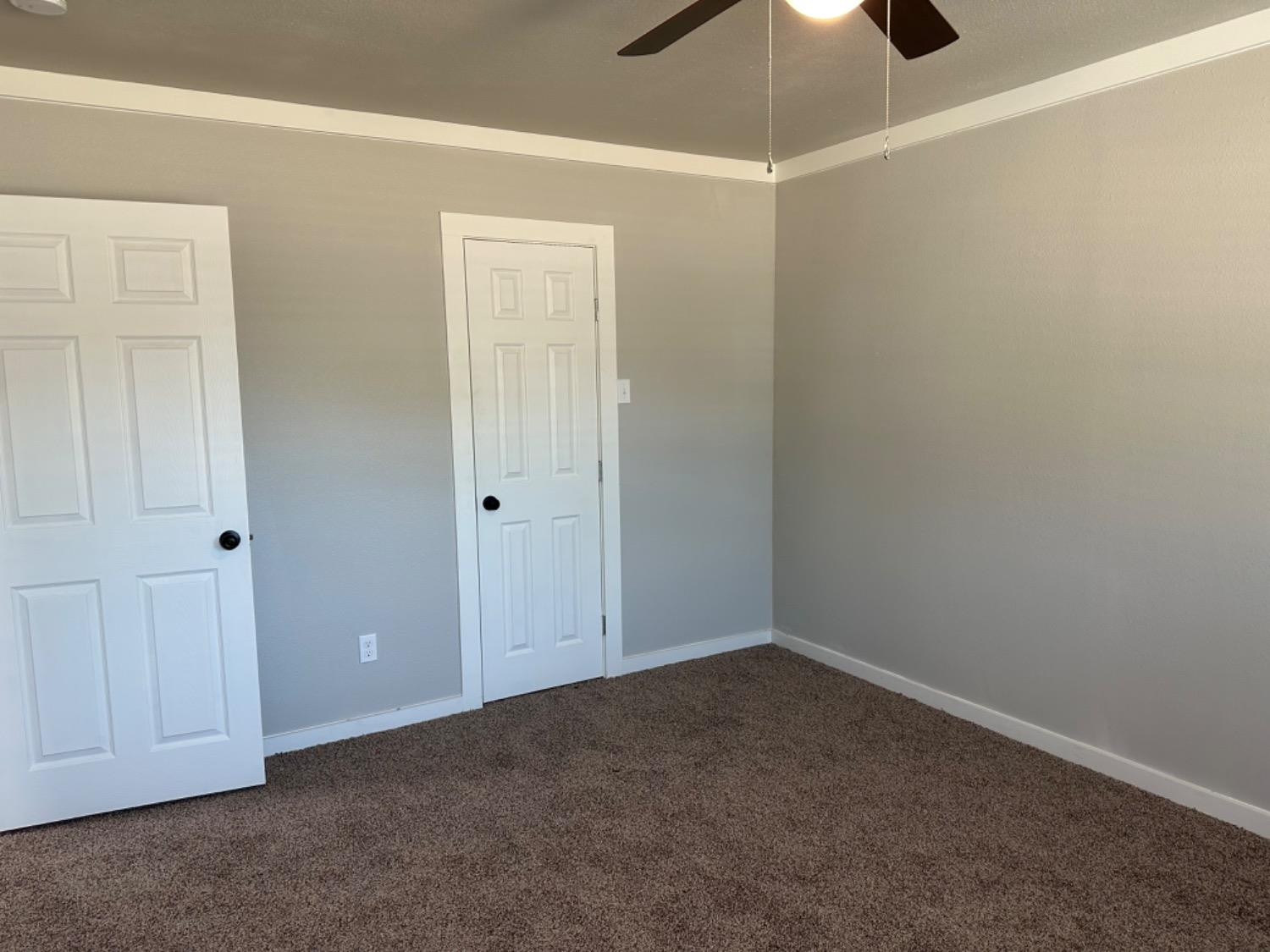 3408 29th Street Lubbock, TX 79410 - Photo 12 of 19 an empty room with a ceiling fan and closet area