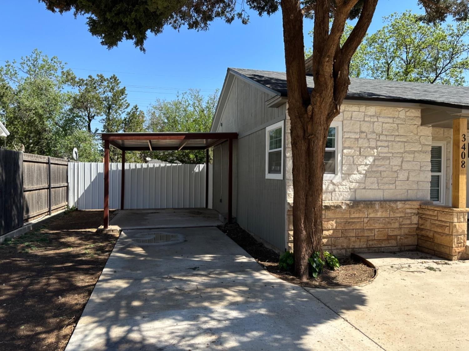 3408 29th Street Lubbock, TX 79410 - Photo 16 of 19 a backyard of a house with a tree