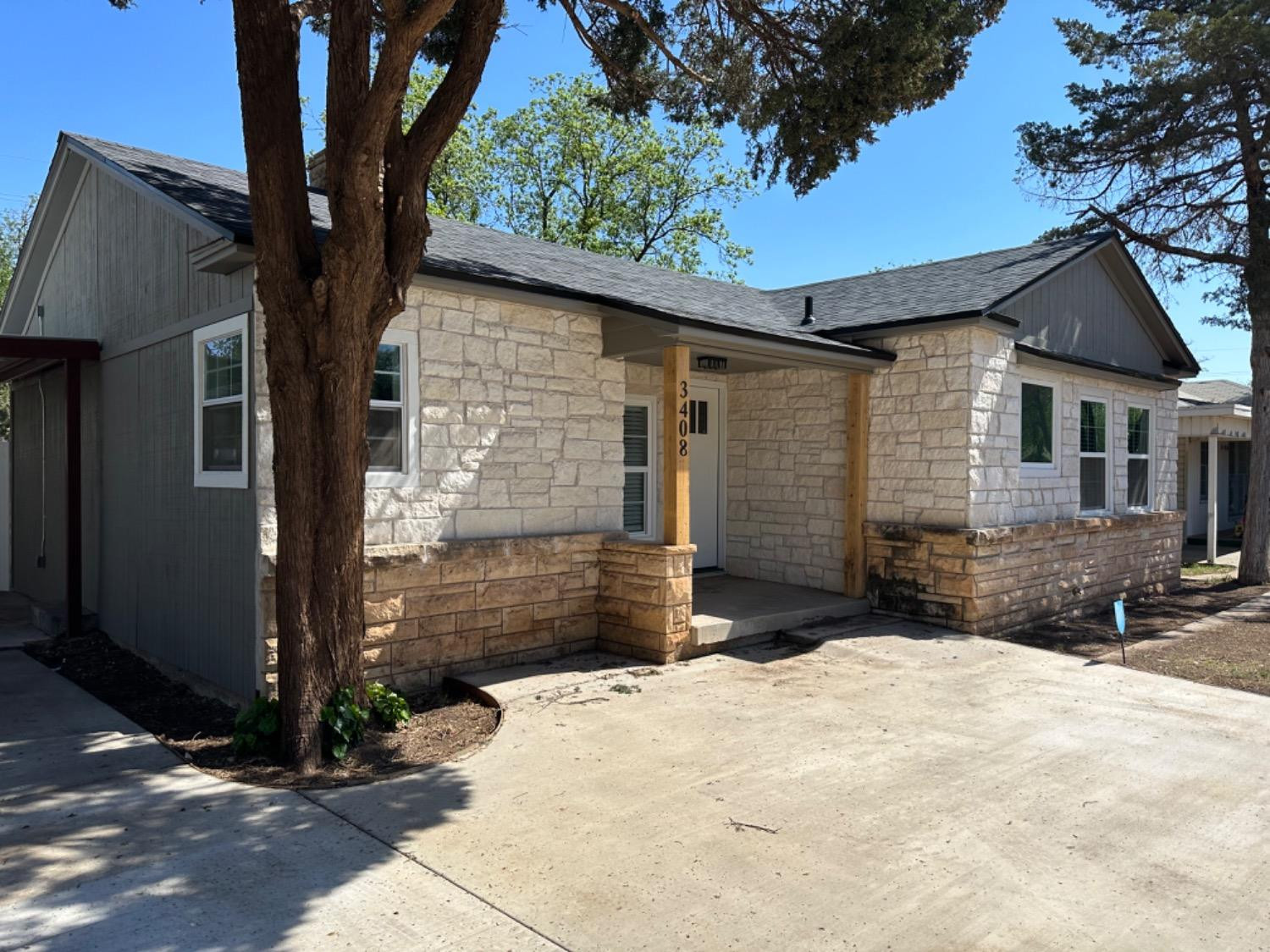 3408 29th Street Lubbock, TX 79410 - Photo 17 of 19 a front view of a house with a yard
