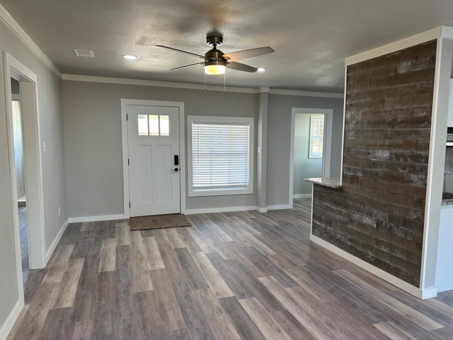 3408 29th Street Lubbock, TX 79410 - Photo 6 of 19 wooden floor in an empty room with a window