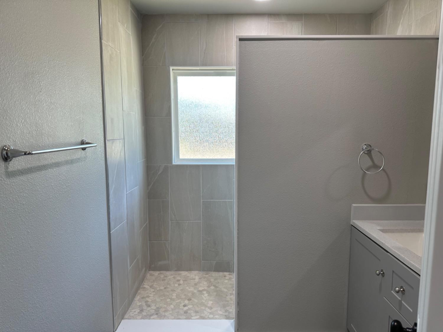 3408 29th Street Lubbock, TX 79410 - Photo 7 of 19 a bathroom with a sink and shower