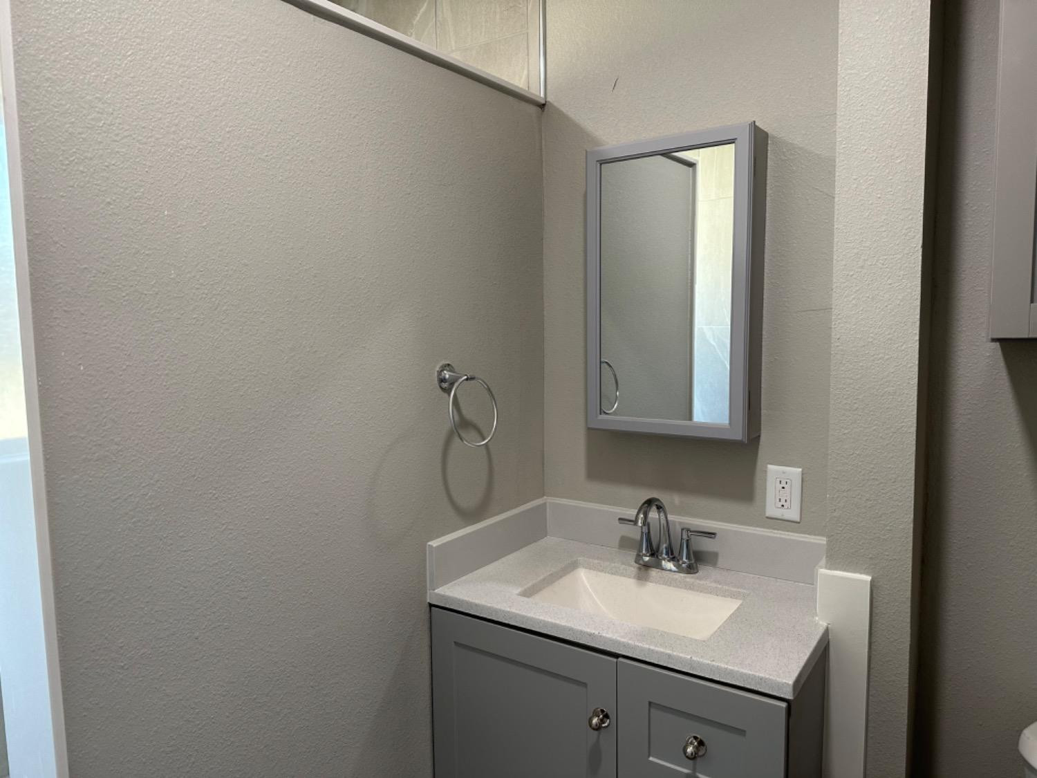 3408 29th Street Lubbock, TX 79410 - Photo 10 of 19 a bathroom with a sink and a mirror