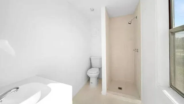 a bathroom with a toilet and shower