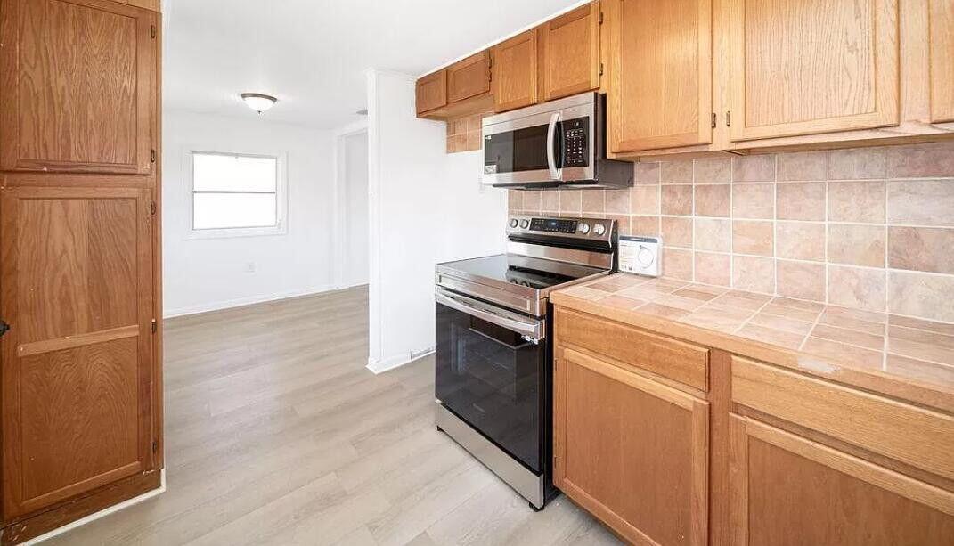 1520 Hunter Road, Unit A Okeechobee, FL 34974 - Photo 4 of 20 a kitchen with stainless steel appliances a stove microwave and sink