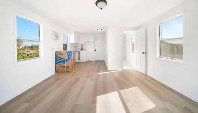 a view of kitchen with furniture and wooden floor