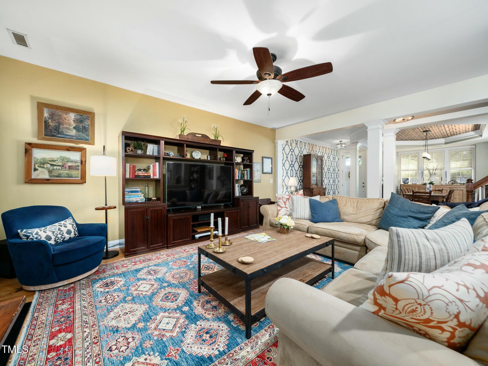 4210 Falls River Avenue Raleigh, NC 27614 - Photo 18 of 53 a living room with furniture and a flat screen tv