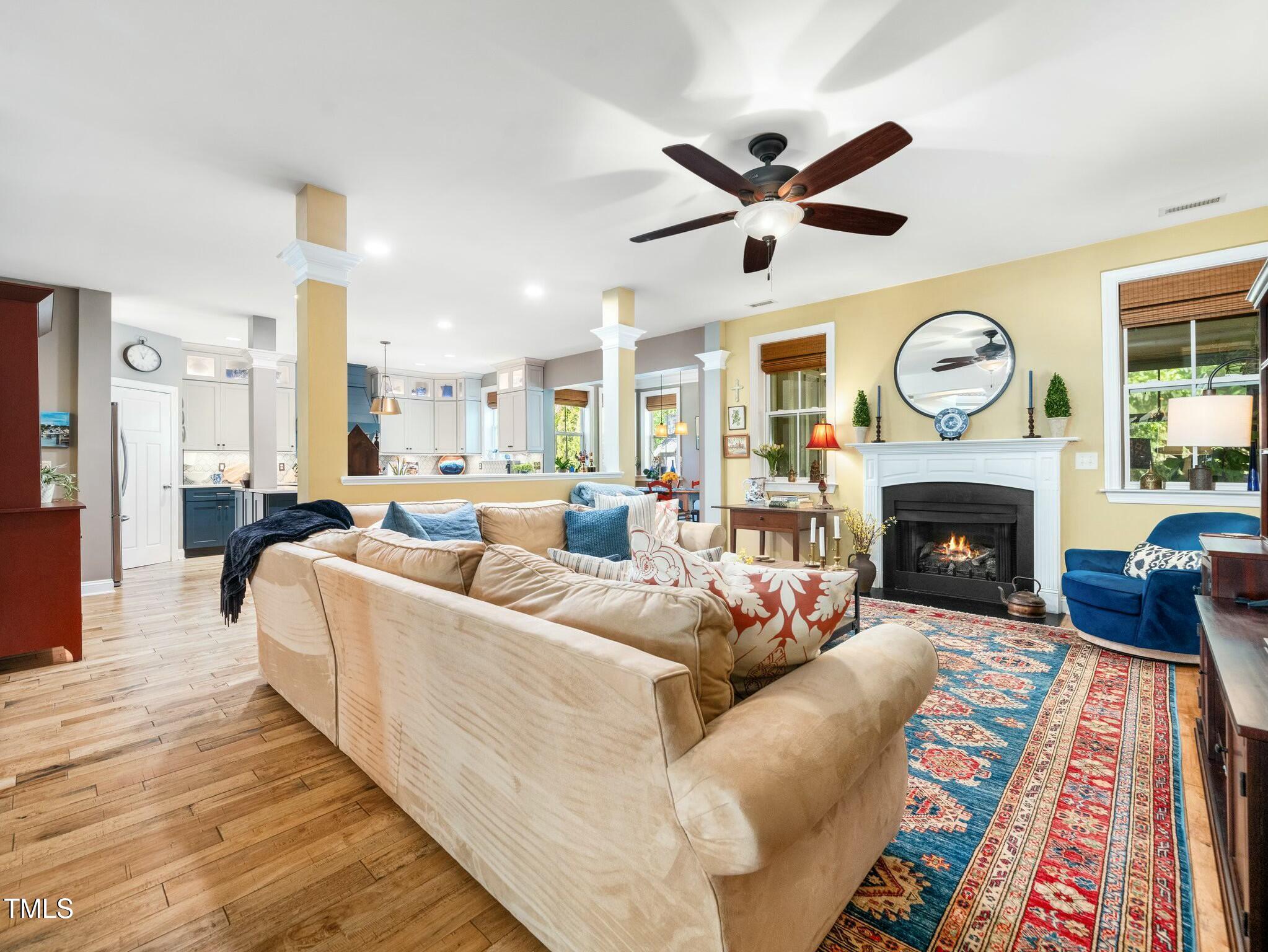 4210 Falls River Avenue Raleigh, NC 27614 - Photo 19 of 53 a living room with furniture a fireplace and a large window