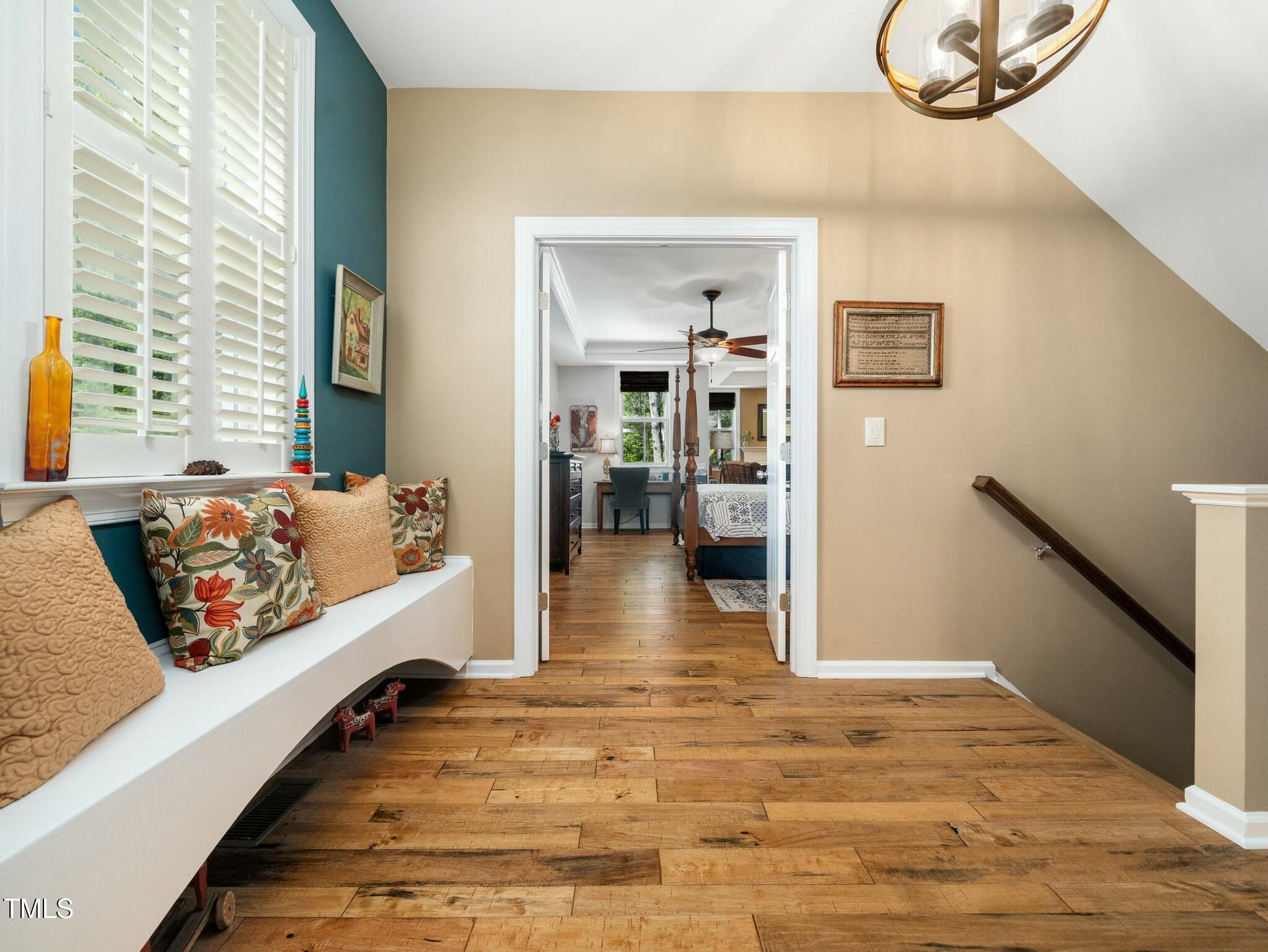 4210 Falls River Avenue Raleigh, NC 27614 - Photo 21 of 53 a view of a bedroom with wooden floor and a rug