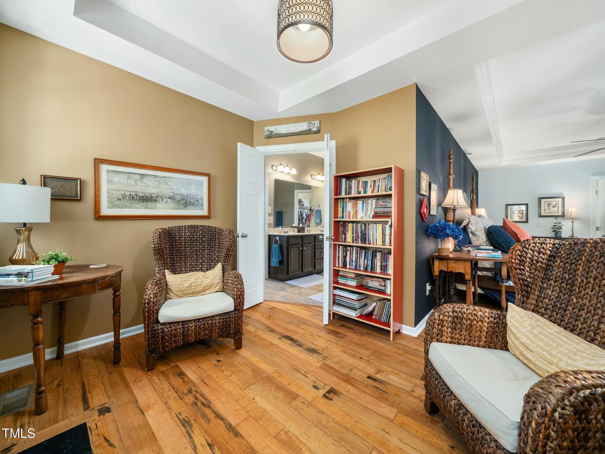 4210 Falls River Avenue Raleigh, NC 27614 - Photo 24 of 53 a living room with furniture and a wooden floor