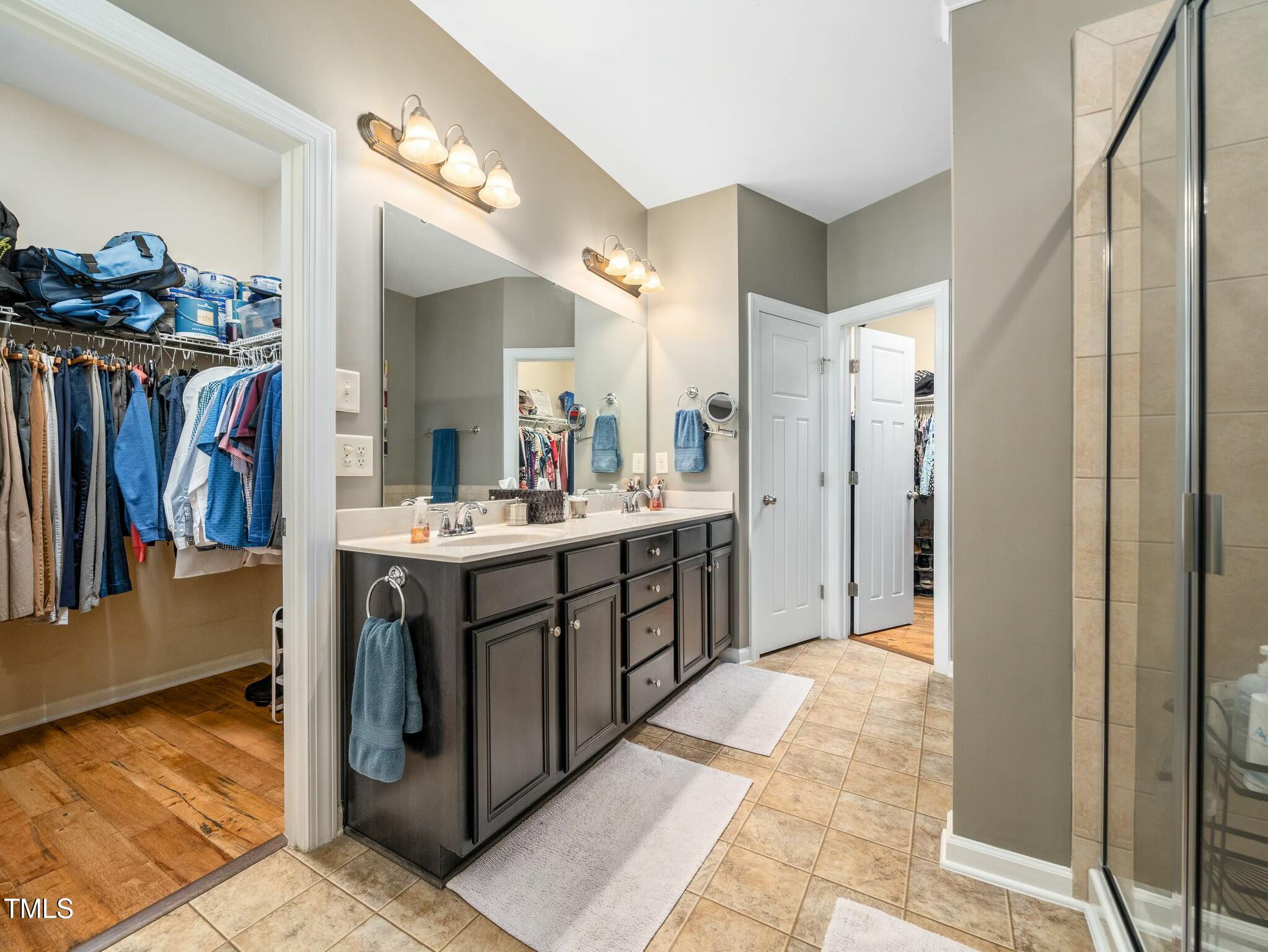 4210 Falls River Avenue Raleigh, NC 27614 - Photo 25 of 53 a bathroom with a sink double vanity and a mirror