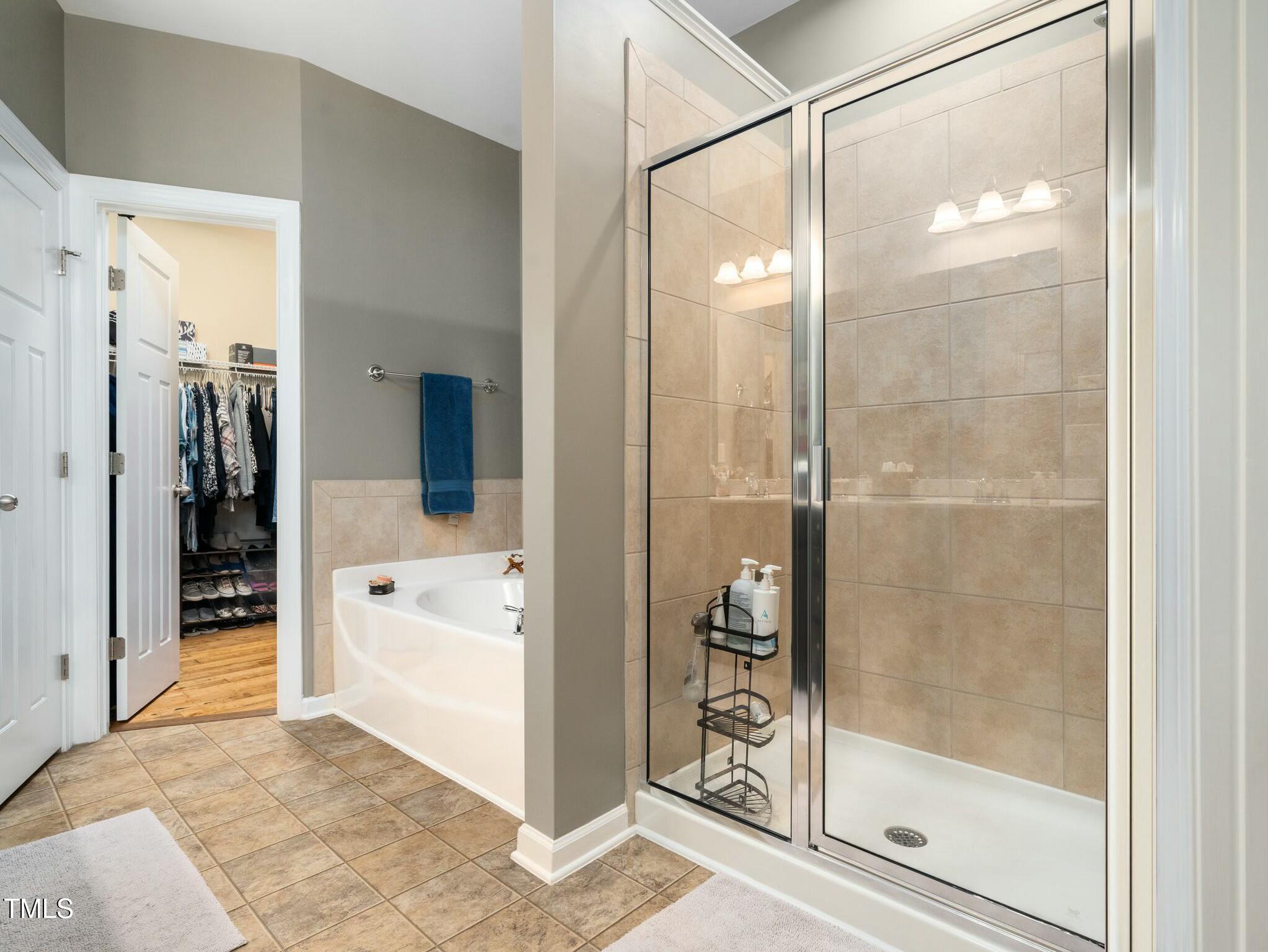 4210 Falls River Avenue Raleigh, NC 27614 - Photo 26 of 53 a bathroom with a glass shower door and a glass door