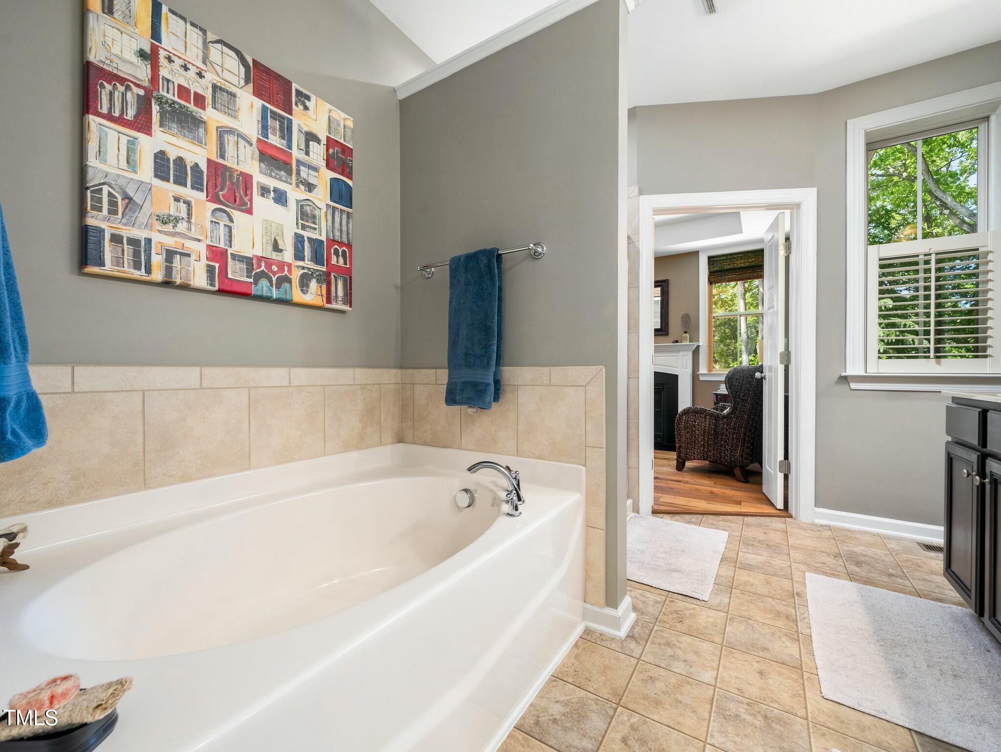 4210 Falls River Avenue Raleigh, NC 27614 - Photo 27 of 53 a spacious bathroom with bathtub and window
