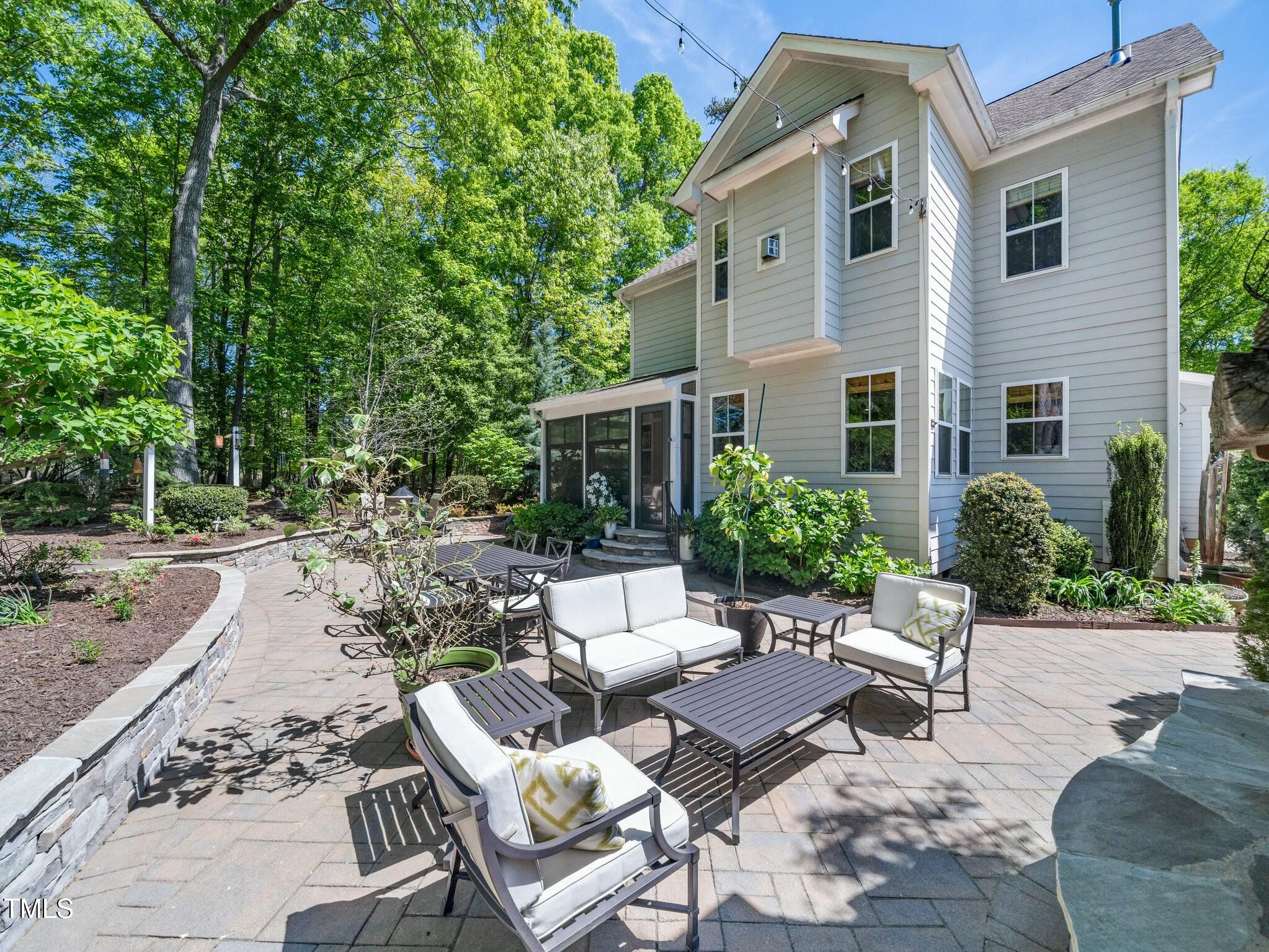 4210 Falls River Avenue Raleigh, NC 27614 - Photo 39 of 53 a view of a patio with couches and a table and chairs with wooden fence