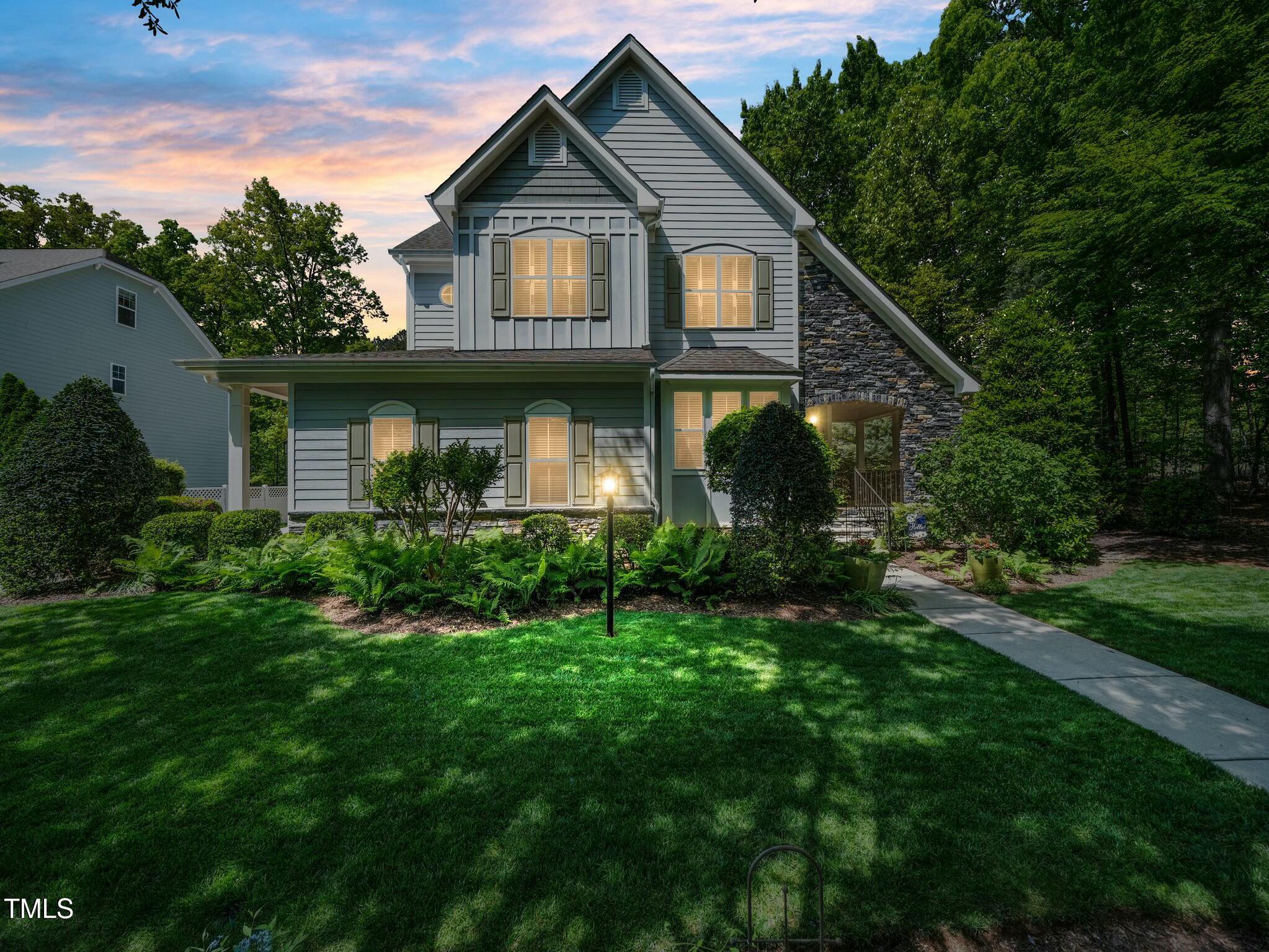 4210 Falls River Avenue Raleigh, NC 27614 - Photo 49 of 53 a front view of a house with a yard and trees