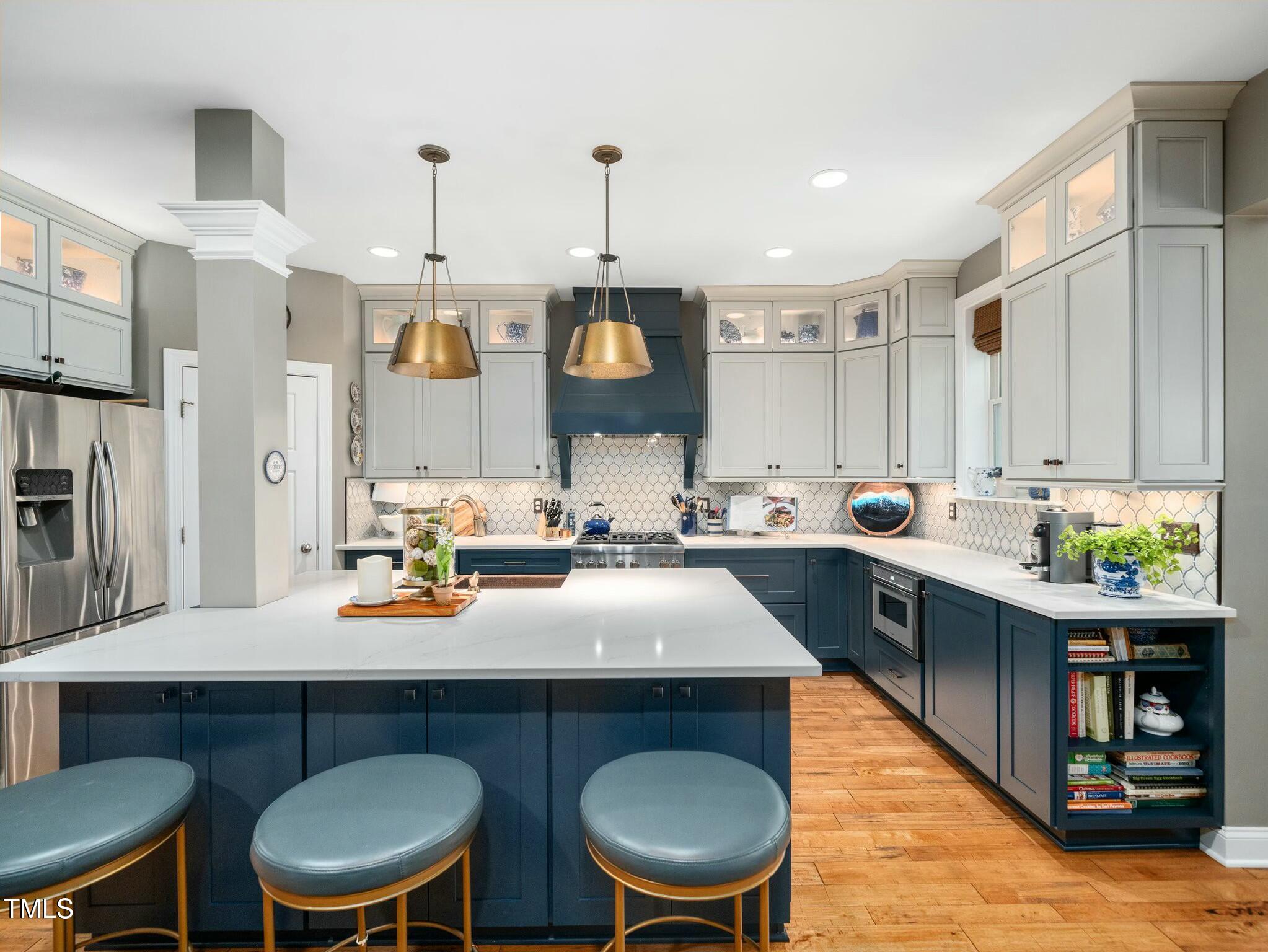 4210 Falls River Avenue Raleigh, NC 27614 - Photo 5 of 53 a kitchen with a table chairs sink and cabinets
