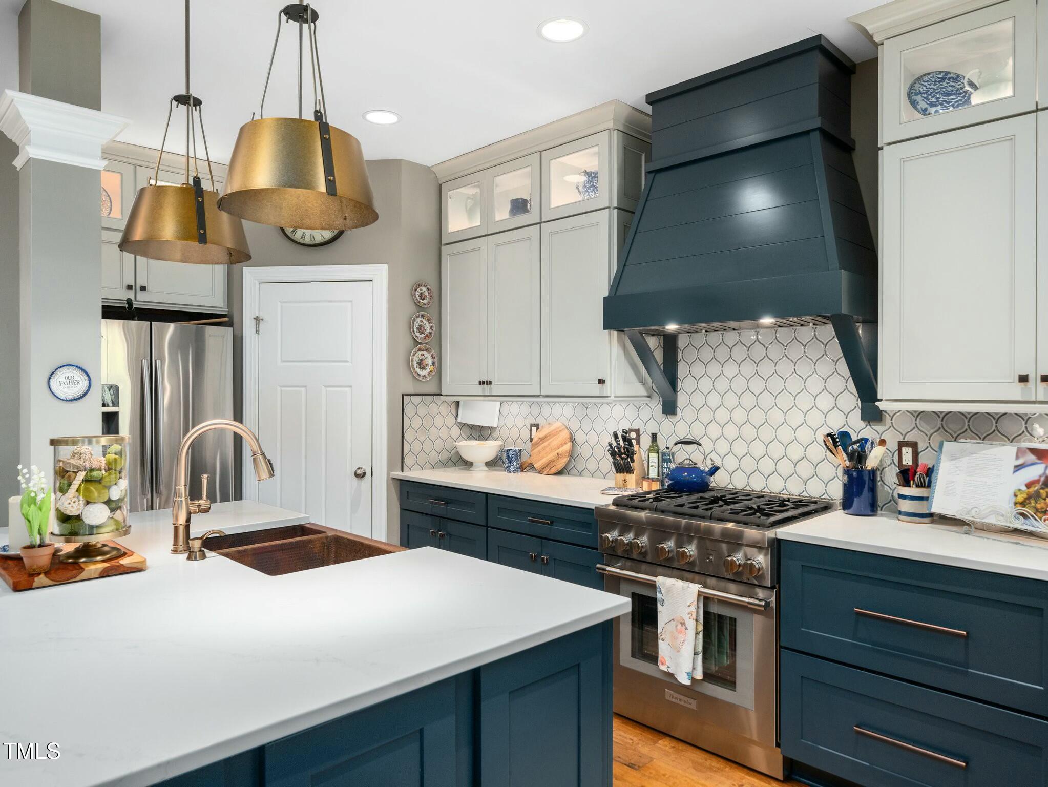 4210 Falls River Avenue Raleigh, NC 27614 - Photo 6 of 53 a kitchen with stainless steel appliances a sink a stove and a wooden floors