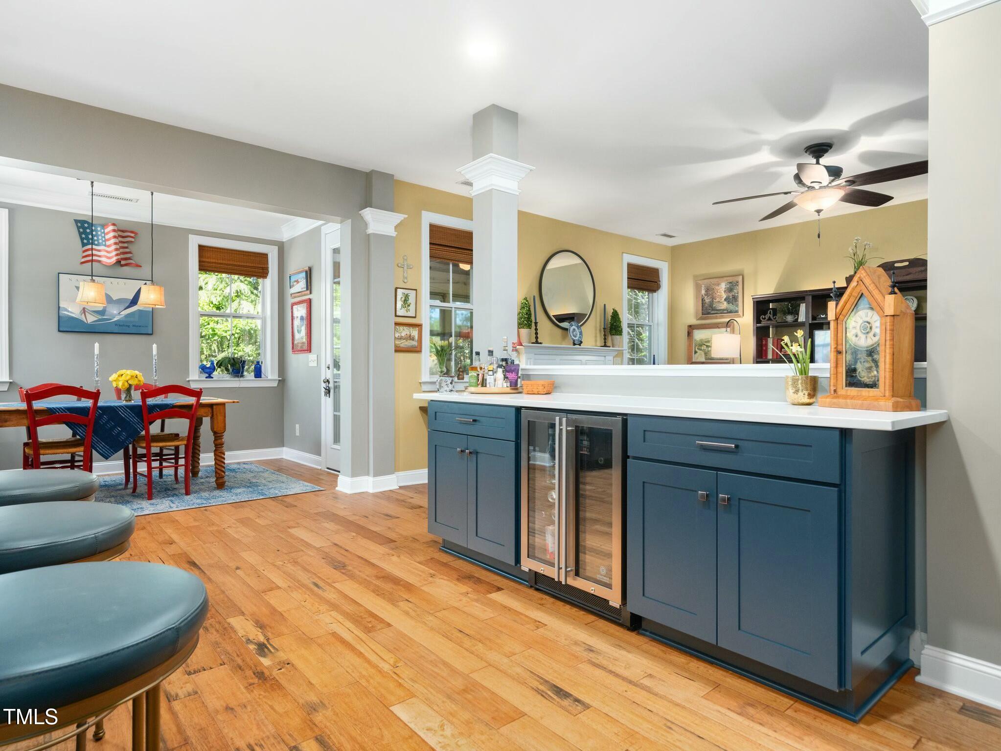 4210 Falls River Avenue Raleigh, NC 27614 - Photo 7 of 53 a living room with stainless steel appliances kitchen island granite countertop a stove a sink a dining table and chairs with wooden floor
