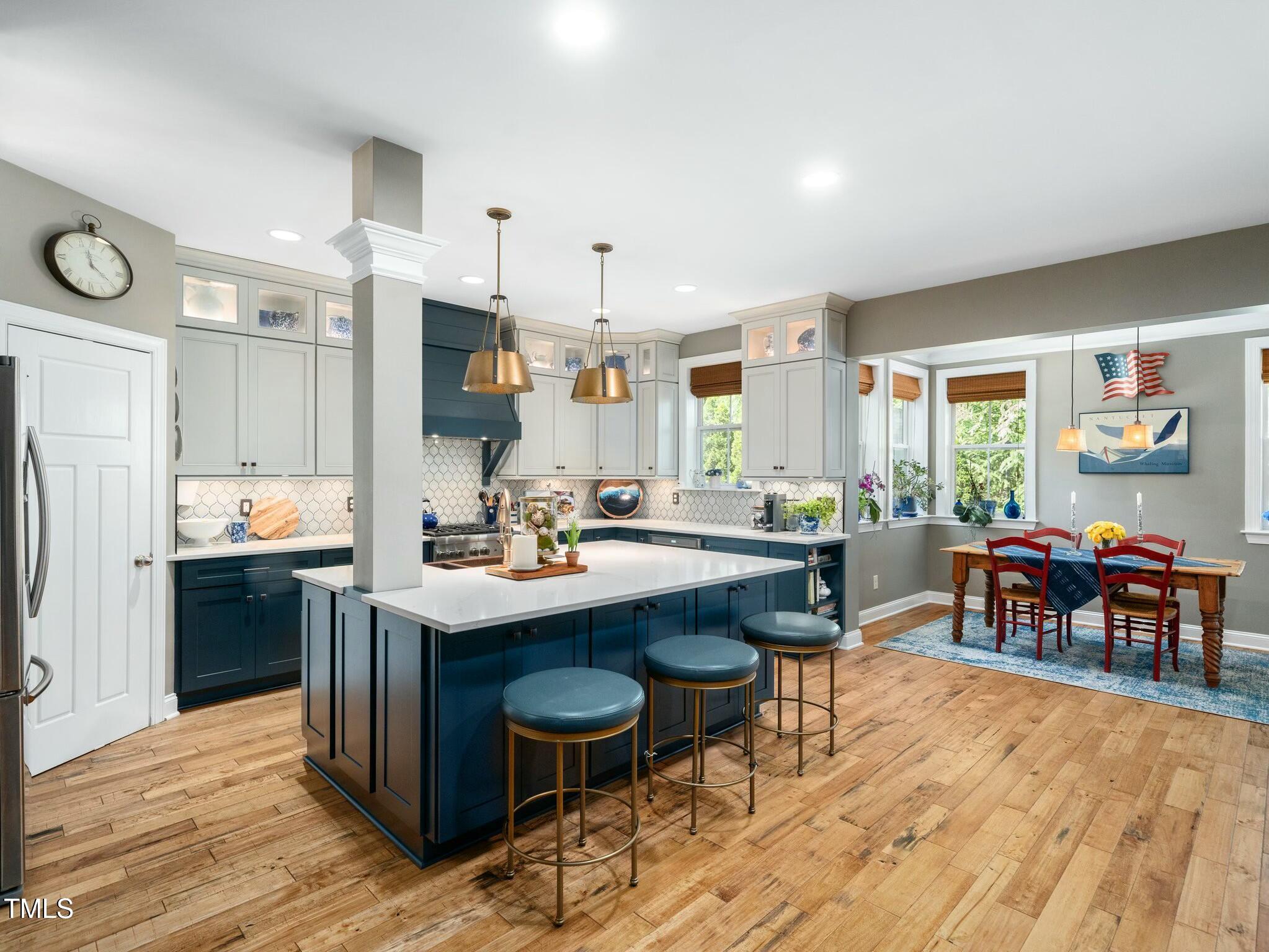 4210 Falls River Avenue Raleigh, NC 27614 - Photo 8 of 53 a kitchen with stainless steel appliances kitchen island granite countertop a sink and cabinets