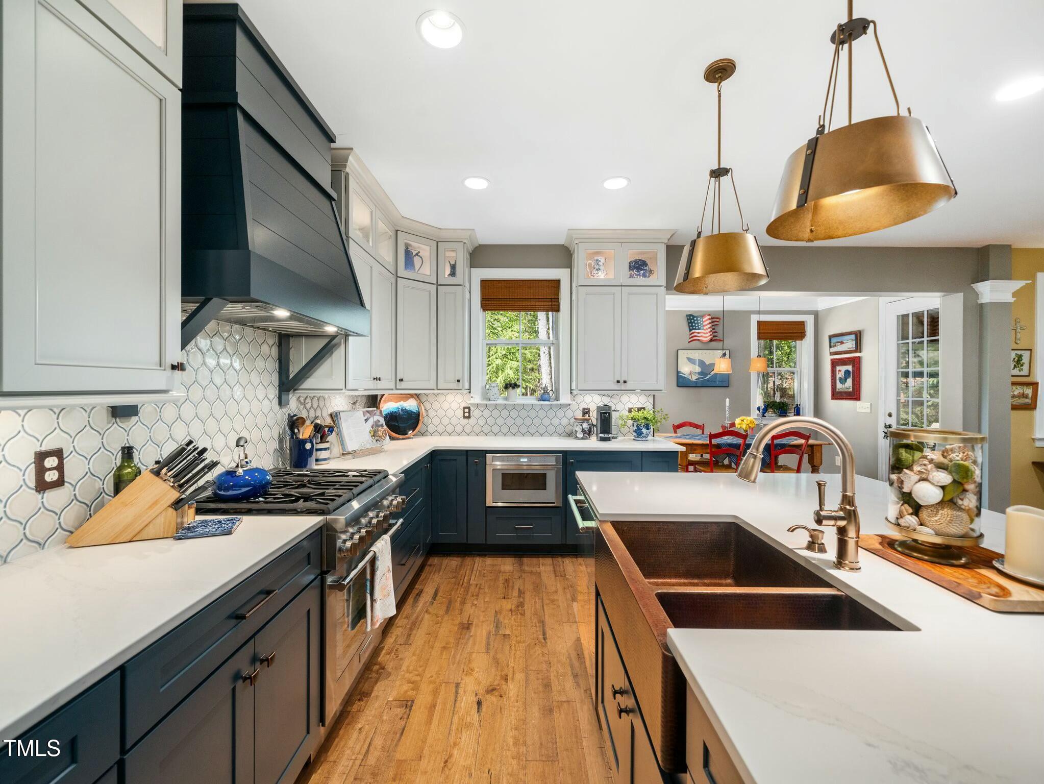 4210 Falls River Avenue Raleigh, NC 27614 - Photo 10 of 53 a kitchen filled counter top space a sink a stove and a window
