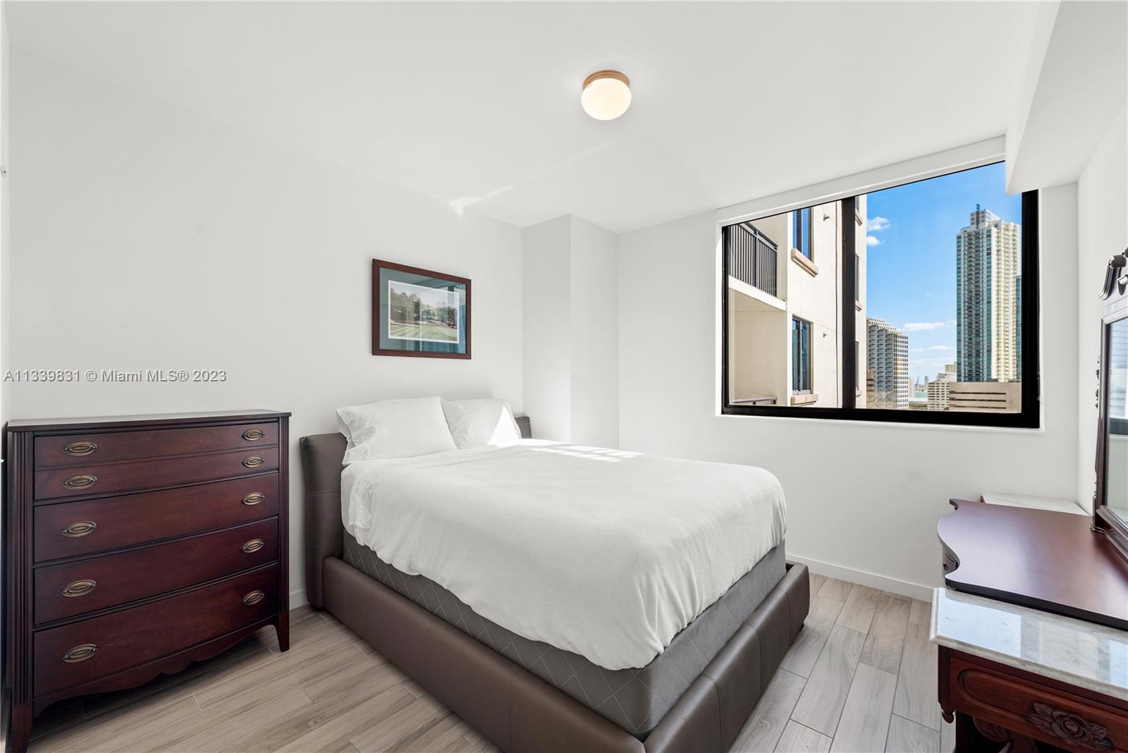 999 Southwest 1st Avenue, Unit 1811 Miami, FL 33130 - Photo 11 of 36 a bedroom with a bed and a window