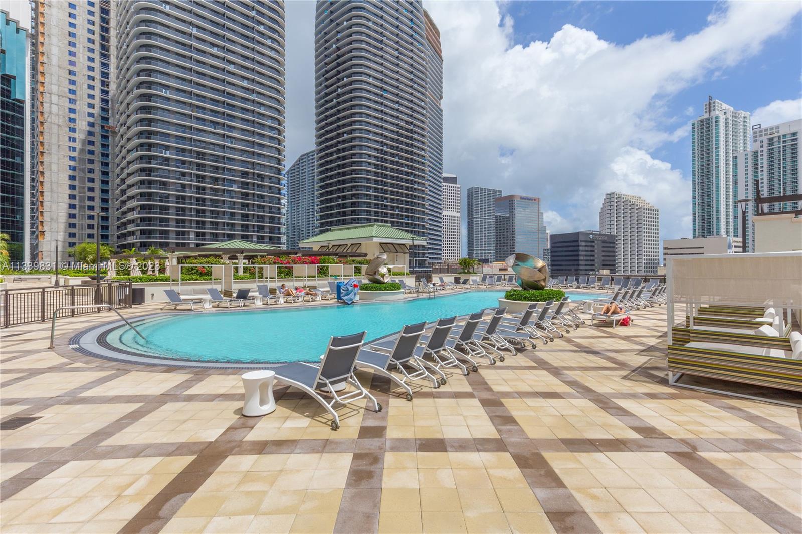 999 Southwest 1st Avenue, Unit 1811 Miami, FL 33130 - Photo 19 of 36 a swimming pool with outdoor seating and yard