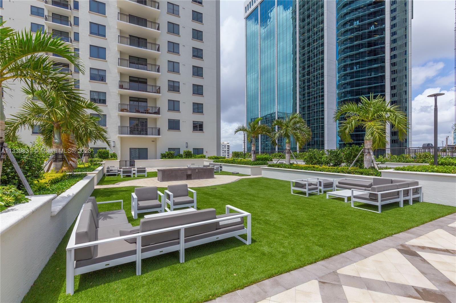 999 Southwest 1st Avenue, Unit 1811 Miami, FL 33130 - Photo 23 of 36 a view of a patio with a table and chairs