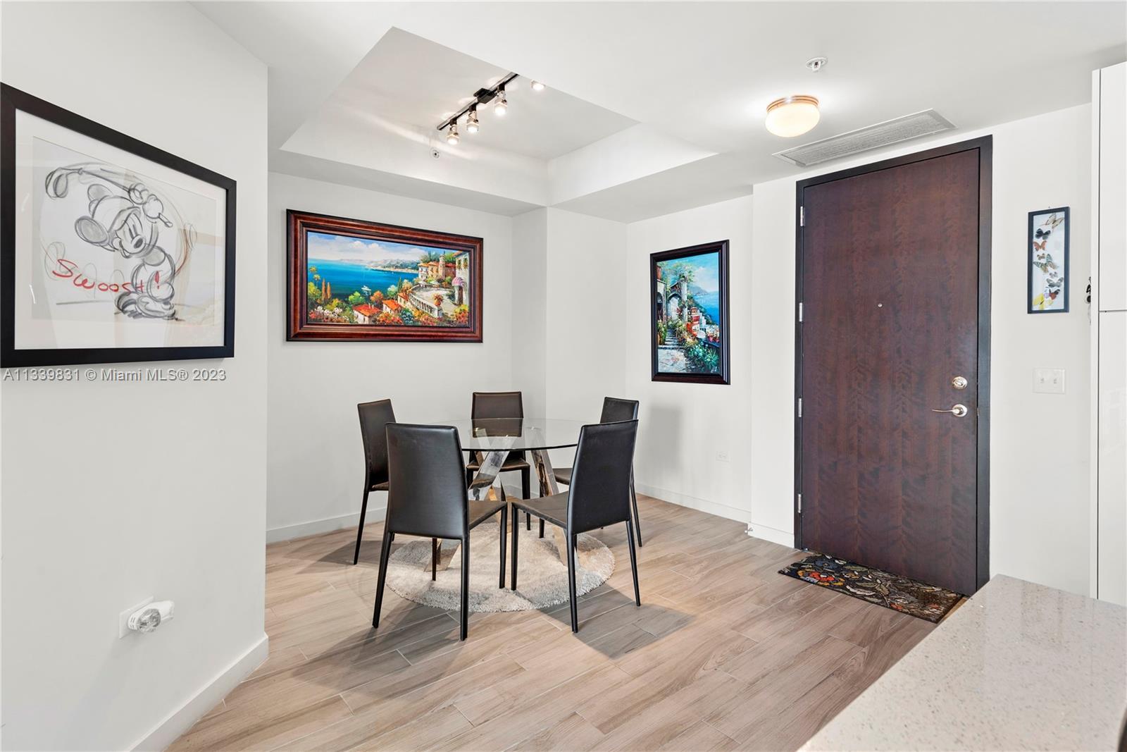 999 Southwest 1st Avenue, Unit 1811 Miami, FL 33130 - Photo 6 of 36 a view of a dining room with furniture and wooden floor