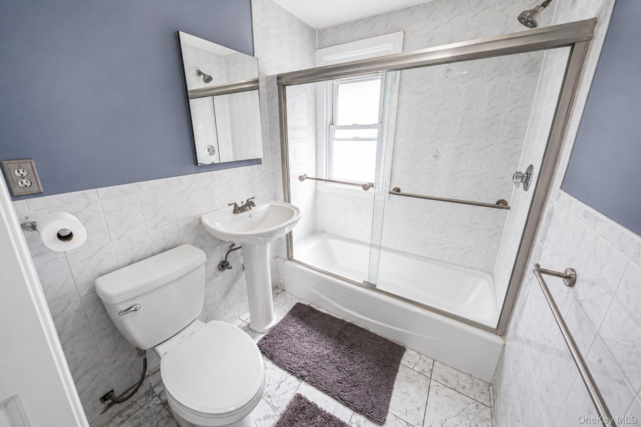 93-20 92nd Avenue Queens, NY 11421 - Photo 16 of 21 a white toilet sitting next to a bathroom sink