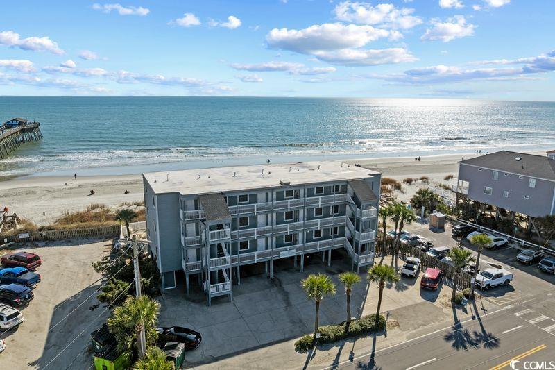 116 South Waccamaw Drive, Unit 207 Murrells Inlet, SC 29576 - Photo 1 of 27 Drone / aerial view of apartment complex / building and waterfront with a beach