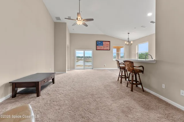 a view of a livingroom with furniture and a window