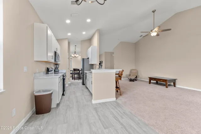a view of kitchen and sink with wooden floor