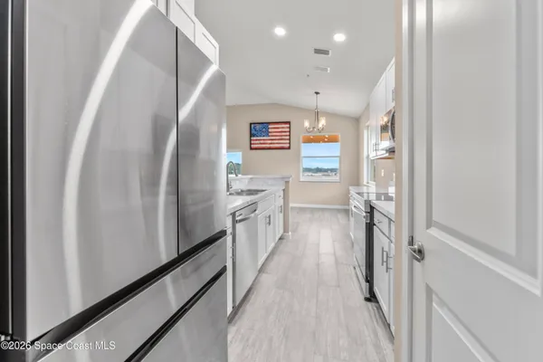 a kitchen with stainless steel appliances a refrigerator and a refrigerator