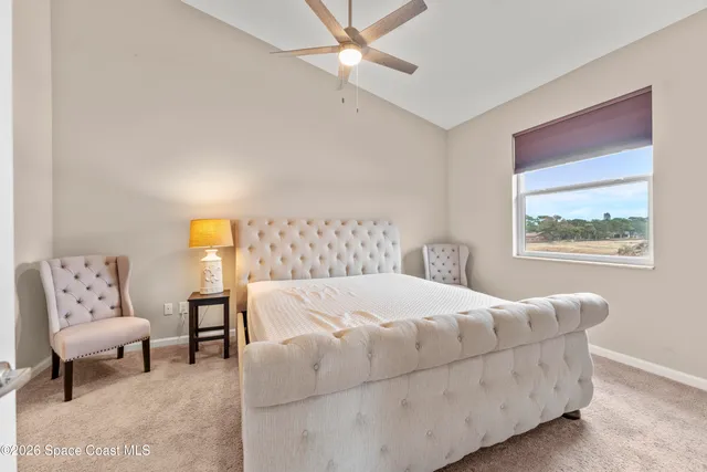 a bedroom with a large bed and a couch