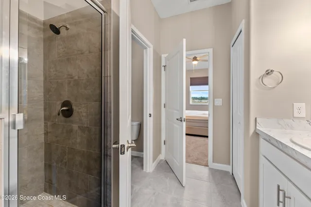 a bathroom with a shower and a sink