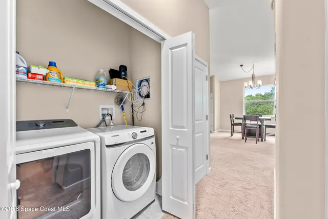 a view of storage and utility room with washer and dryer