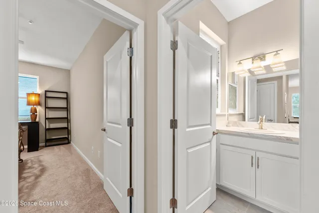 a bathroom with a double vanity sink and a mirror