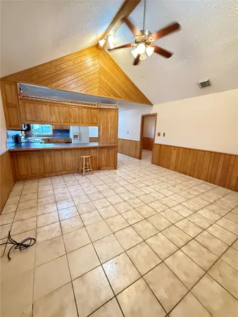 a bedroom with a bed and a ceiling fan