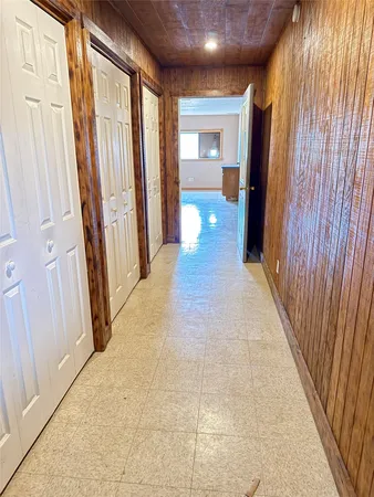 a view of a hallway with wooden floor and curtain