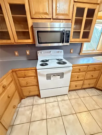 a stove top oven sitting inside of a kitchen