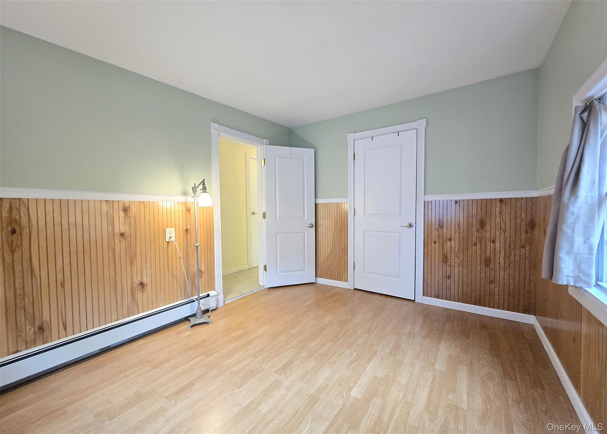 170 Forge Road Calverton, NY 11933 - Photo 14 of 23 a view of an empty room with wooden floor