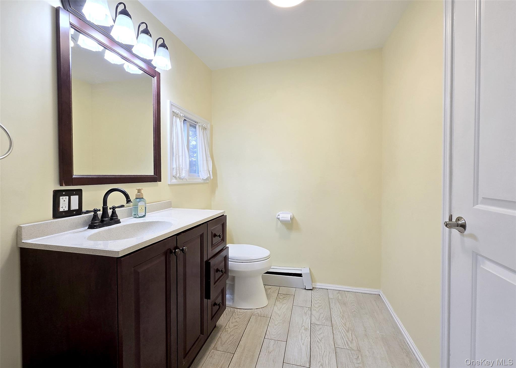 170 Forge Road Calverton, NY 11933 - Photo 18 of 23 a bathroom with a sink and a mirror