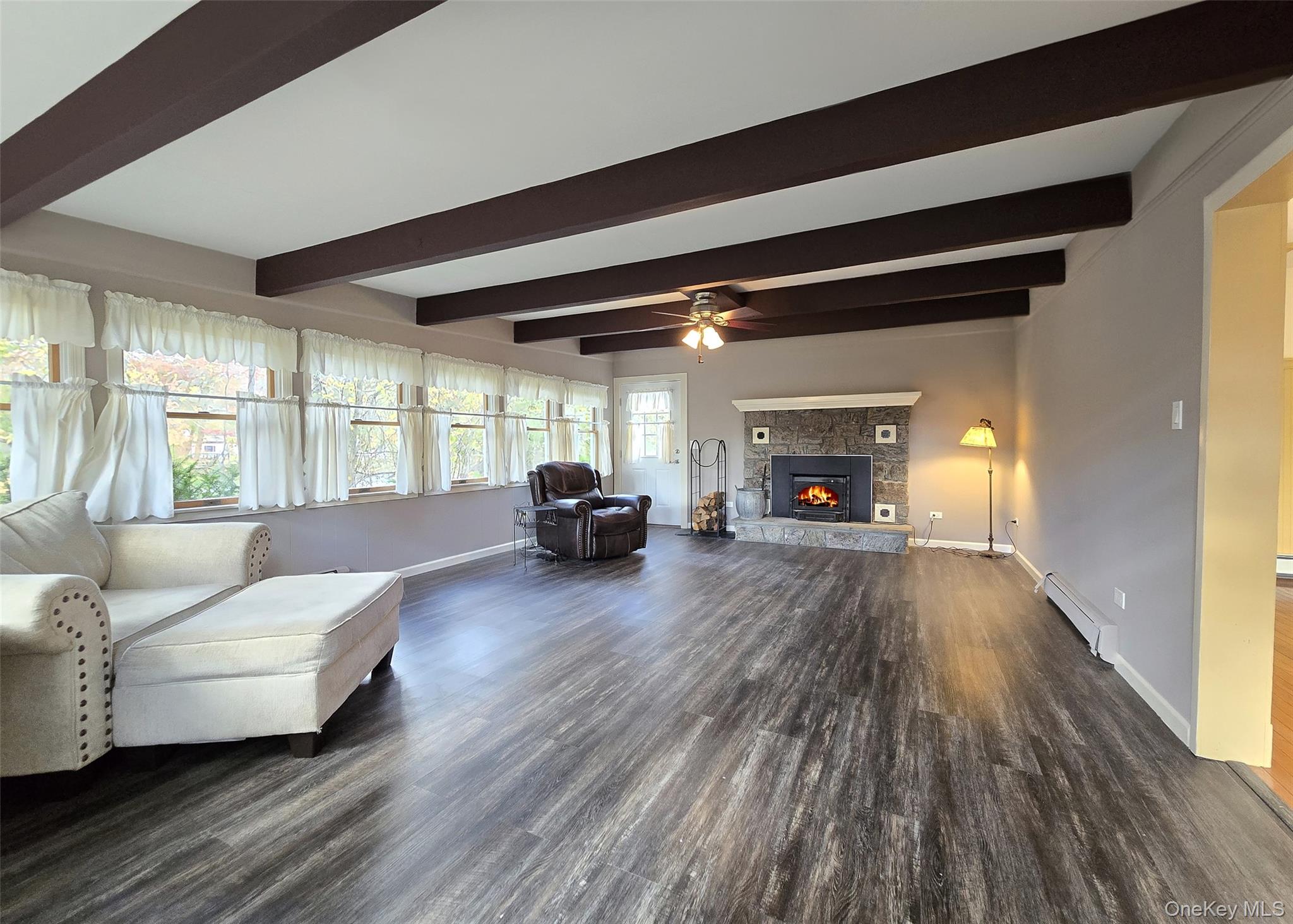 170 Forge Road Calverton, NY 11933 - Photo 2 of 23 a living room with furniture and a fireplace