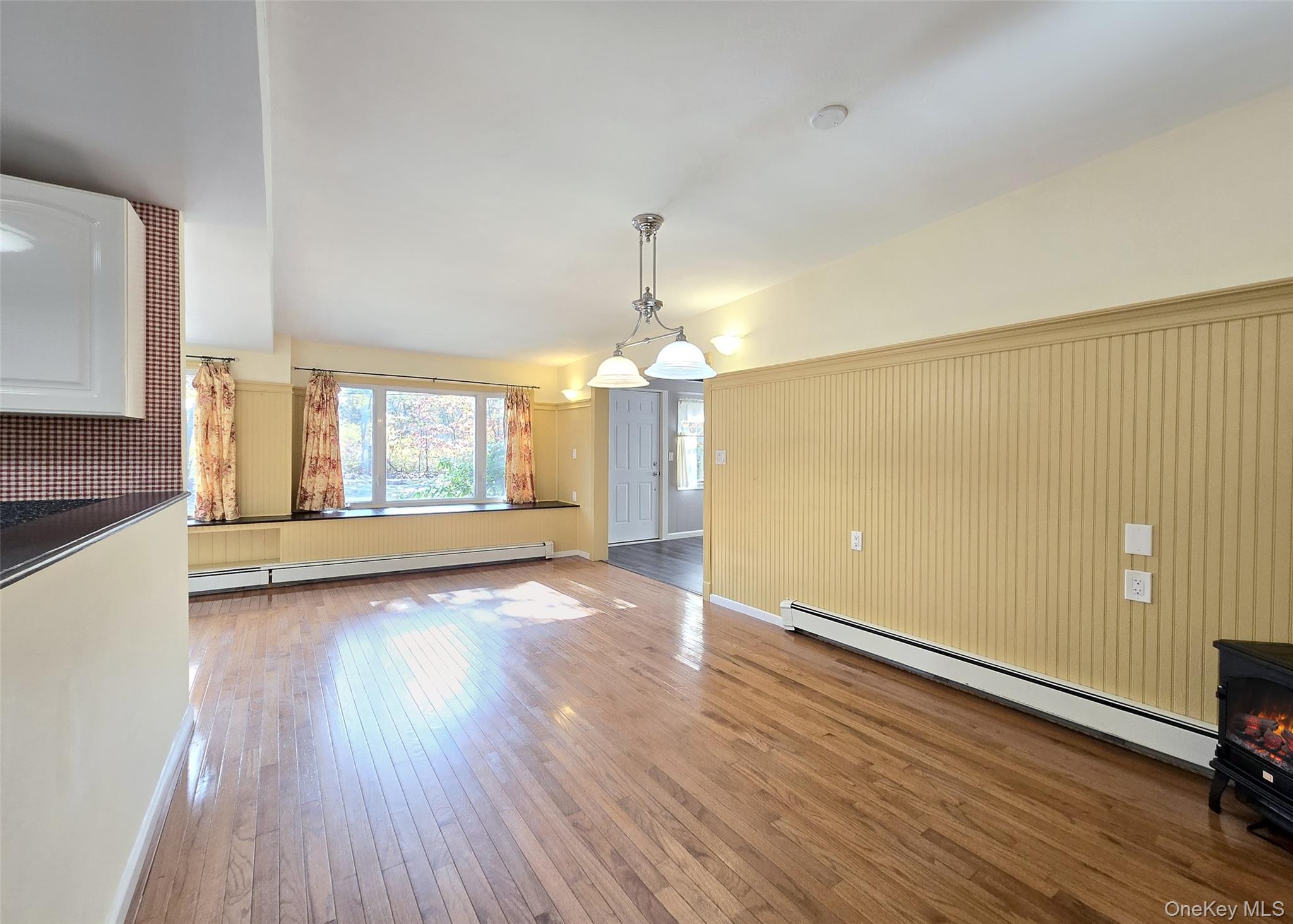 170 Forge Road Calverton, NY 11933 - Photo 8 of 23 an empty room with wooden floor and windows