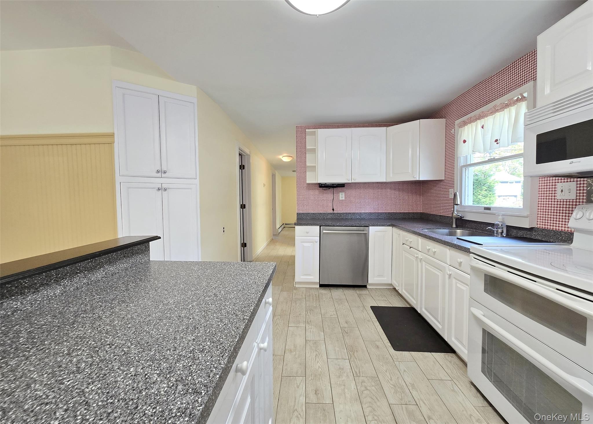 170 Forge Road Calverton, NY 11933 - Photo 10 of 23 a kitchen with granite countertop a sink stainless steel appliances and cabinets
