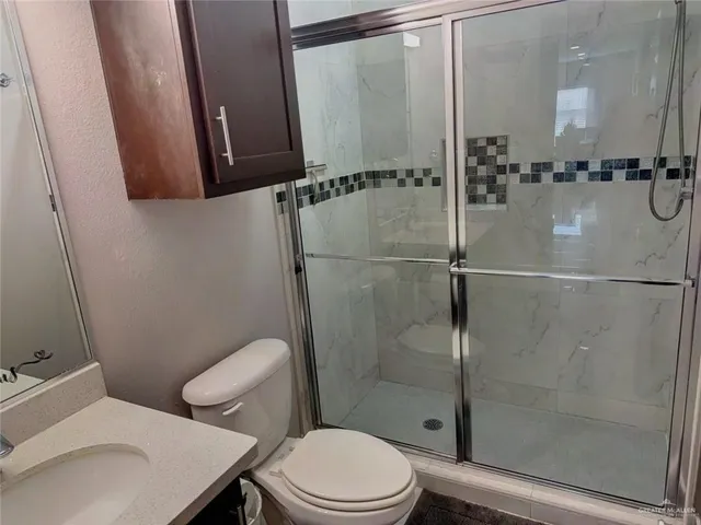 a bathroom with a toilet and a shower