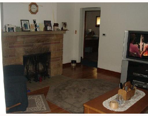 204 Rovel Street Apollo, PA 15613 - Photo 6 of 8 Living Room. Living Room with Hardwood Flooring, Stone wood burning fireplace, ceramic hearth,replacement of plaster walls and paint.
