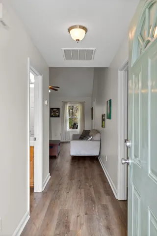 a living room with furniture and a wooden floor